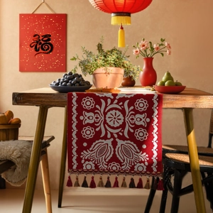 Chinese New Year red table runner with floral embroidery and colorful tassels for festival decor