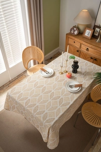 Detailed texture of beige and gold geometric leaf pattern on cotton linen tablecloth
