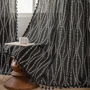 Elegant black cafe curtain with white floral vine print and tassel trim for windows