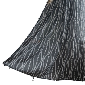 Black kitchen curtain with white wavy floral print and tassel edges for small windows