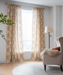Detail of yellow damask curtains with cotton linen texture and small tassel fringe