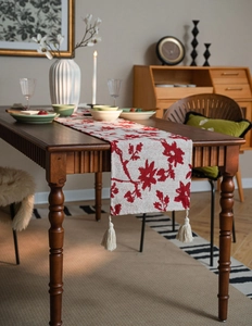 Detailed view of Nordic floral jacquard table runner with decorative cream tassels