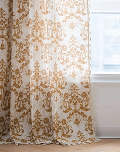 Detail of damask pattern curtain with white tassels and elegant fabric texture