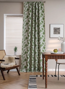 Dettaglio della tenda crema con motivo a vite verde ed eleganti frange beige con nappe