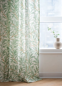 Close-up detail of green willow leaf prints on semi-sheer cotton linen curtain