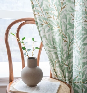 Close-up of botanical green leaf print curtain made of breathable cotton linen fabric