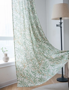 Close-up of green leaf and gold branch print on semi-blackout kitchen window curtain