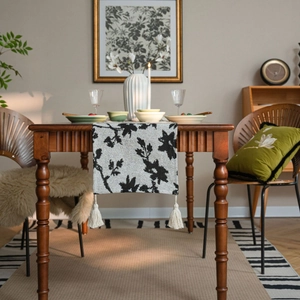 Nordic black and white floral jacquard table runner with decorative cream tassels