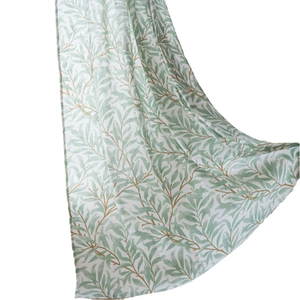Green botanical leaf print curtain on white background with elegant vertical drape