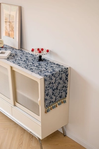 Detailed view of Nordic blue leaf jacquard table runner with hanging tassel fringe