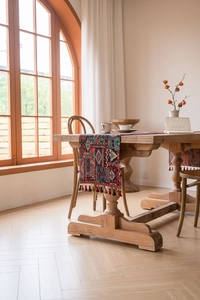 Detailed close-up of geometric jacquard table runner with decorative fringe tassels
