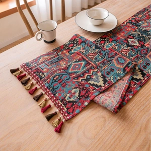 Bohemian jacquard table runner with red geometric patterns and colorful tassels