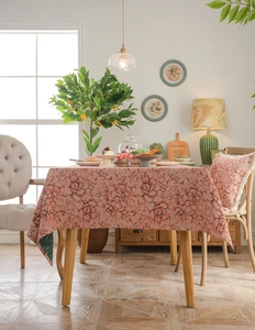 Close-up of thick vintage jacquard tablecloth with embossed rose patterns in brick red