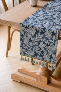 Jacquard table runner with navy blue leaves pattern and colorful decorative tassels