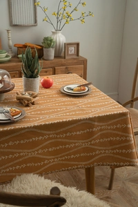 Detail of orange floral patterns on a heavy cotton linen rectangular tablecloth