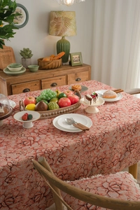 Close-up of vintage pink floral jacquard tablecloth with textured rose patterns