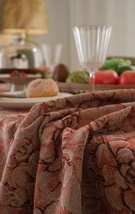 Detail of floral jacquard tablecloth fabric showing thick texture and woven patterns