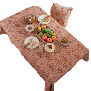 Pink floral jacquard tablecloth with matching tasseled cushion for elegant dining decor