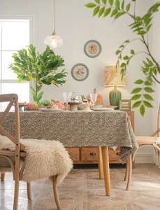 Macro detail of retro floral jacquard tablecloth with high density weave on wooden table