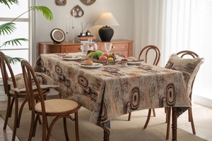 Detail of abstract jacquard tablecloth with textured weave and delicate fringe edges