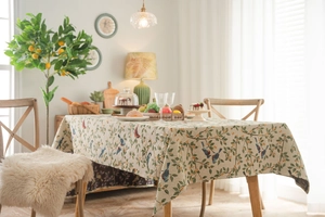 Close-up of bird and floral jacquard patterns on thick beige rectangle tablecloth