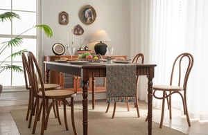 Close-up of jacquard table runner featuring vintage floral patterns and tassel trim details
