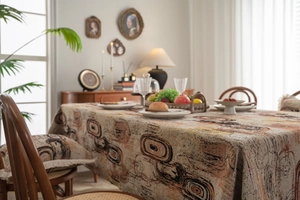 Detailed view of thick jacquard tablecloth with orange and brown geometric patterns