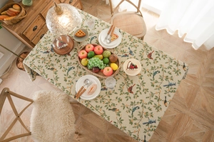 Detail of American style jacquard tablecloth with elegant birds and floral patterns