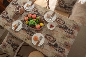 Close-up of jacquard tablecloth with abstract rings and matching chair cushion decor