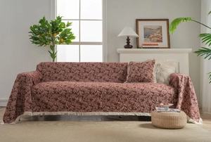 Detailed texture of jacquard floral sofa cover with vintage fringe edges in cozy living room
