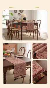Close-up of vintage red floral jacquard table runner with decorative tassel accents