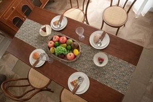Detail of Nordic jacquard table runner with floral pattern on dark wood dining table