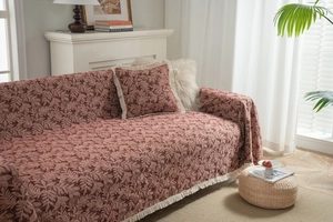 Detailed view of bohemian vintage sofa blanket with leaf texture and cream fringe trim