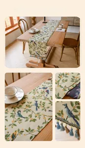 Detail of jacquard table runner with bird floral patterns and elegant blue fringe tassels