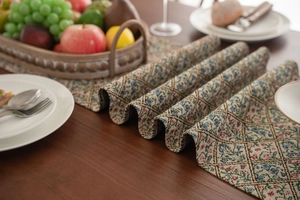Detailed close-up of thick jacquard table runner with vintage floral and rhombus patterns