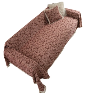 Retro jacquard sofa cover with floral leaf pattern and white fringe in brick red chenille
