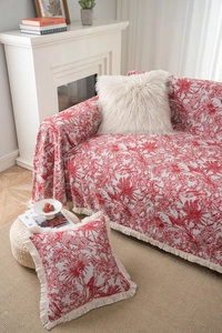 Detail of red and white Toile de Jouy patterned throw blanket with decorative fringe