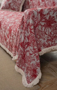 Close-up of red Toile de Jouy jacquard sofa throw with leopard print and fringe