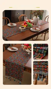Close-up of colorful woven plaid table runner with blue and beige tassel details