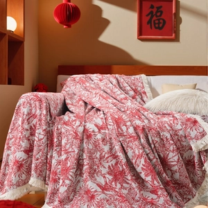 Festive red jacquard sofa throw blanket with cream tassels and intricate floral patterns