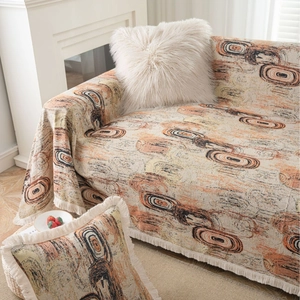 Jeté de canapé moderne aux motifs abstraits de vortex avec glands décoratifs