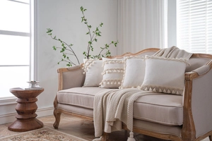 Detailed close-up of bohemian cream cushion covers with elegant fringe and textured patterns