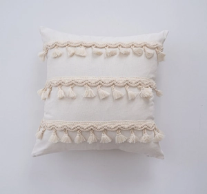 Detailed view of bohemian square pillow cover with handmade woven bands and tassels