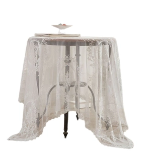 Elegant white lace tablecloth with floral embroidery and scalloped edges for round tables
