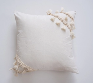 Detailed view of bohemian canvas pillow cover with handmade tassel fringe decoration
