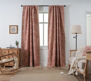 Detail of pink floral jacquard curtains featuring elegant white tassel fringes on edges