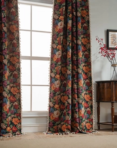 Detail of vintage floral jacquard curtain fabric with decorative white fringe tassels