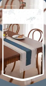 Detail of navy blue and beige woven table runner with intricate hollow crochet and tassels