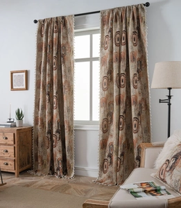Detailed close-up of bohemian concentric circle pattern curtains with elegant cream tassels