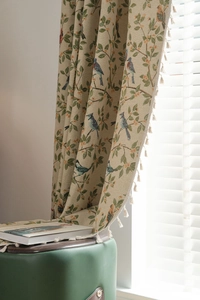 Detailed view of beige jacquard curtain featuring colorful birds and floral embroidery